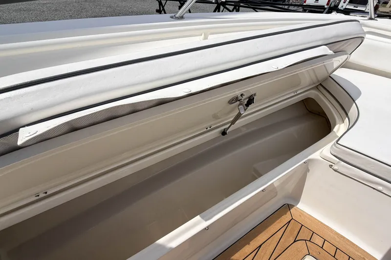Slide: The Image of Open storage compartment on a 2013 Boston Whaler 32 Justice boat, showcasing interior space. - 30