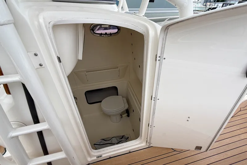 Slide: The Image of Interior view of a 2013 Boston Whaler 32 Justice boat's compact bathroom. - 22
