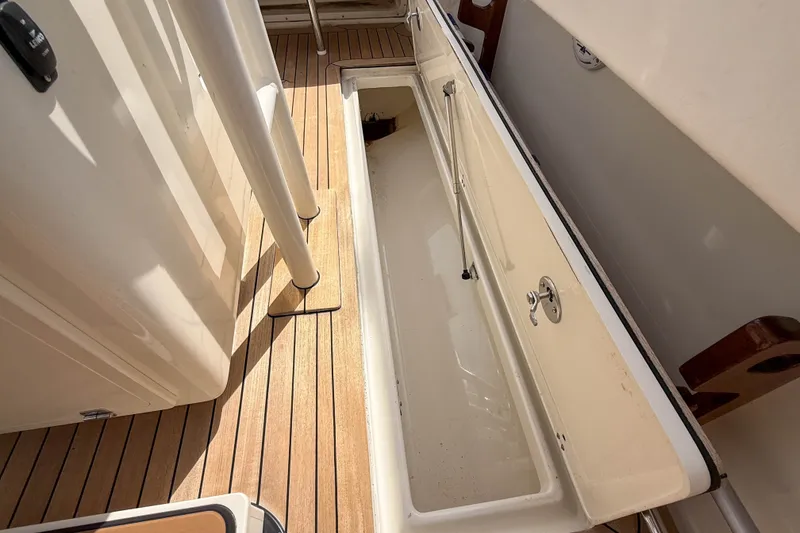 Slide: The Image of Open storage compartment on 2013 Boston Whaler 32 Justice boat deck. - 28