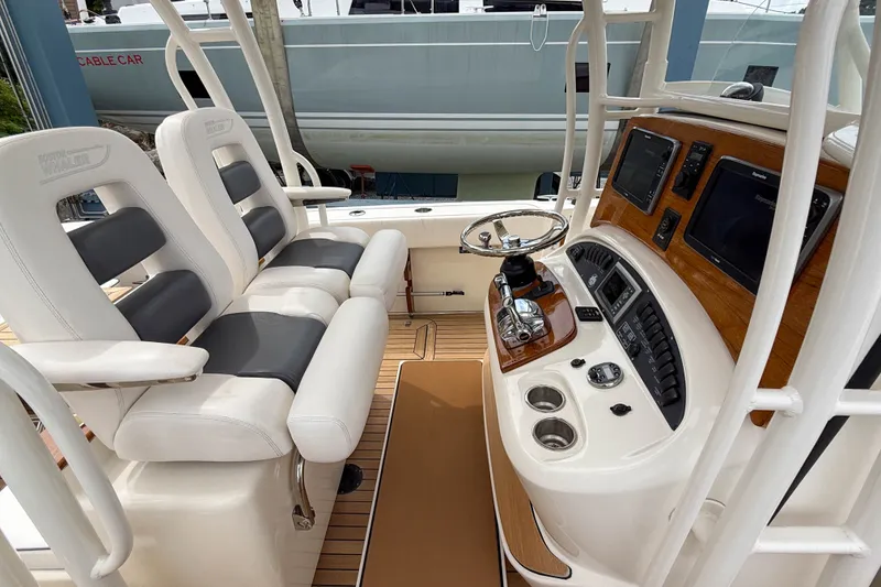 Slide: The Image of 2013 Boston Whaler 32 Justice helm with dual seats and advanced navigation controls. - 11