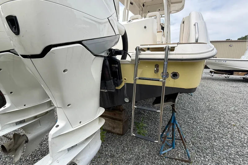Slide: The Image of 2013 Boston Whaler 32 Justice boat with dual outboard motors and boarding ladder. - 6
