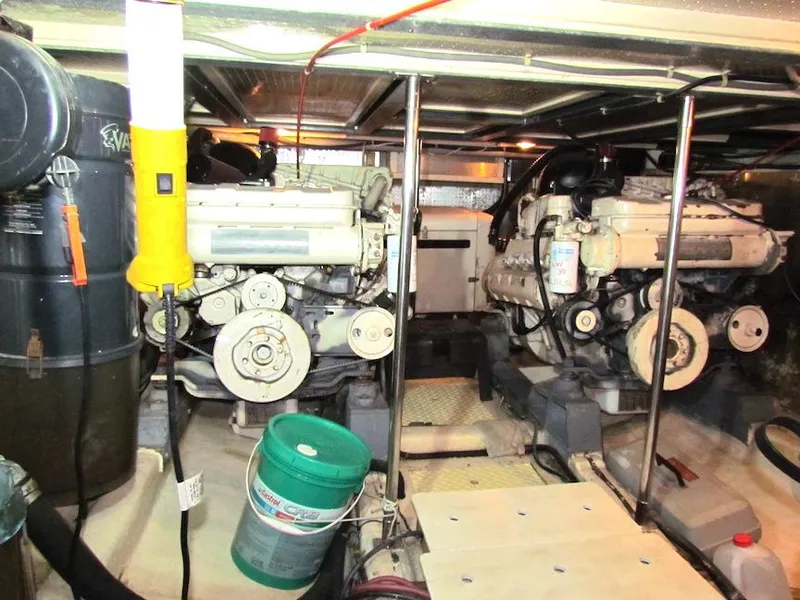 Slide: The Image of Engine room of a 1997 Hyatt 55 yacht with dual engines and maintenance equipment. - 36