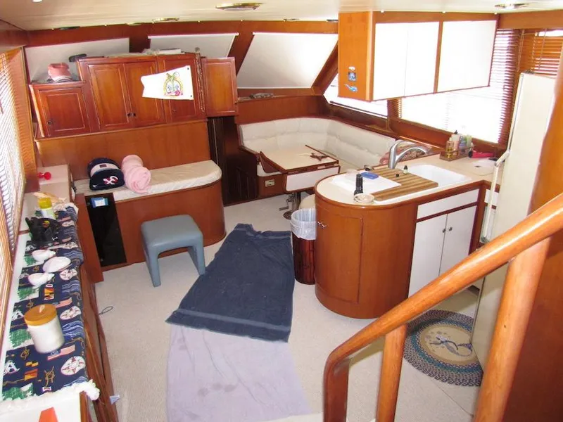 Slide: The Image of Interior of a 1997 Hyatt 55 yacht with wooden cabinetry and cozy seating area. - 11