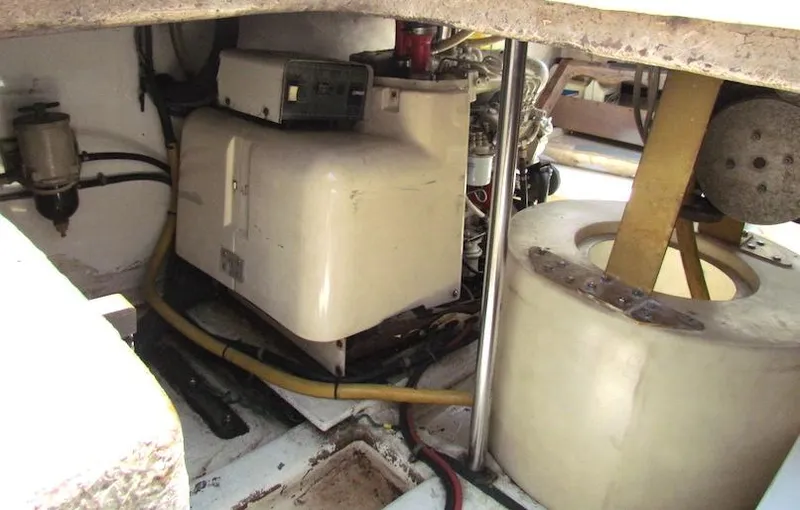 Slide: The Image of Engine compartment of a 1997 Hyatt 55 boat, featuring mechanical components and wiring. - 38