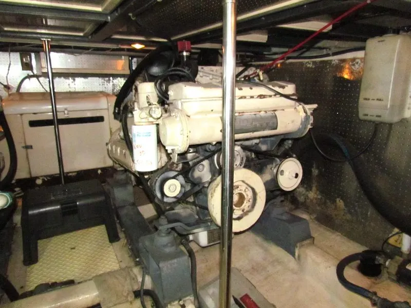 Slide: The Image of Engine room of a 1997 Hyatt 55 yacht, showcasing mechanical components and equipment. - 28