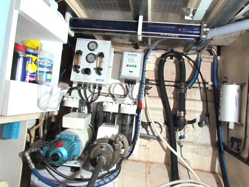 Slide: The Image of Engine room of a 1997 Hyatt 55 yacht with mechanical equipment and control panels. - 27
