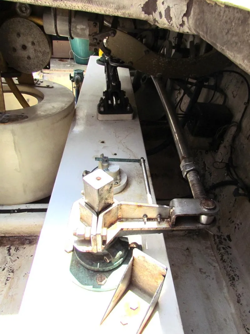 Slide: The Image of Mechanical components of a 1997 Hyatt 55, featuring levers and rods in an industrial setting. - 39