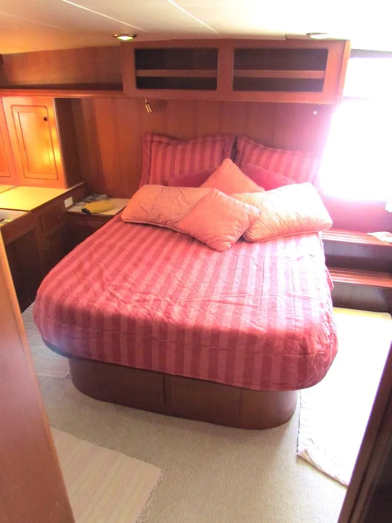 Slide: The Image of Cozy bedroom with pink bedding in a 1997 Hyatt 55 yacht cabin. - 26