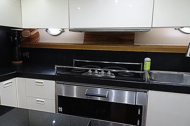 Slide: The Image of Modern kitchen interior on 2010 Azimut 100 Leonardo yacht, featuring sleek appliances and cabinetry. - 48