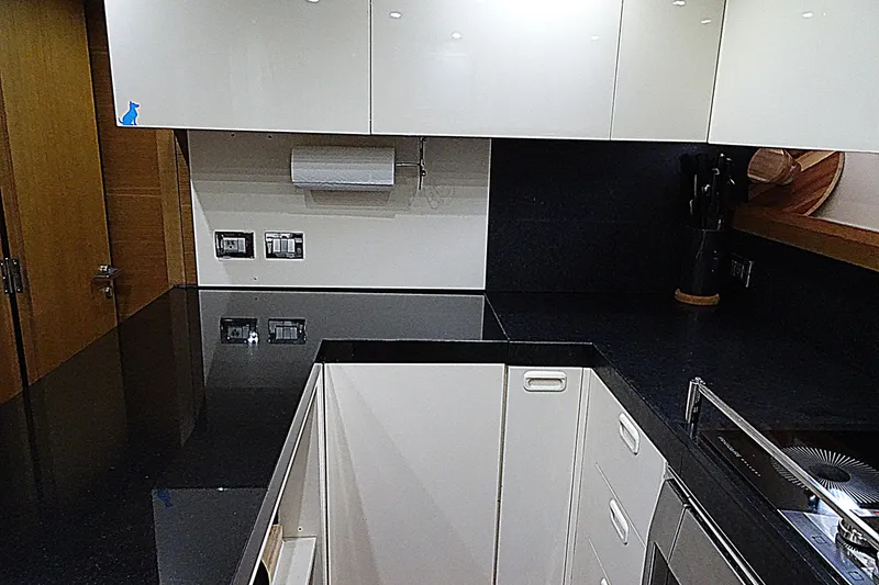 Slide: The Image of Modern kitchen interior on 2010 Azimut 100 Leonardo yacht, featuring sleek countertops and cabinetry. - 50