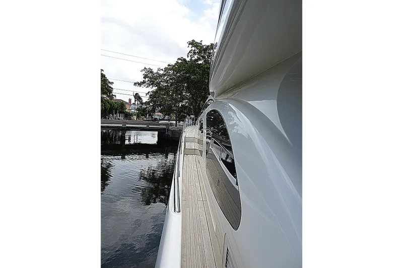 Slide: The Image of Side view of 2010 Azimut 100 Leonardo yacht docked by a calm waterfront. - 83