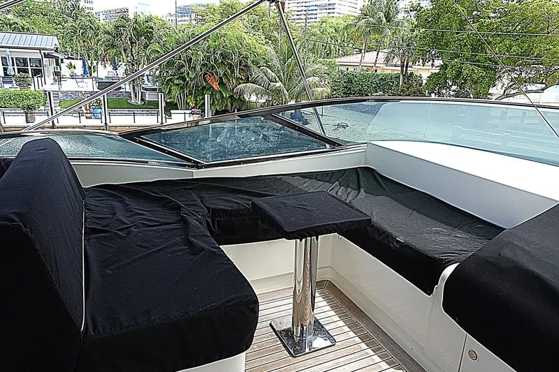 Slide: The Image of Luxurious seating area on 2010 Azimut 100 Leonardo yacht, featuring black cushions and sleek design. - 74