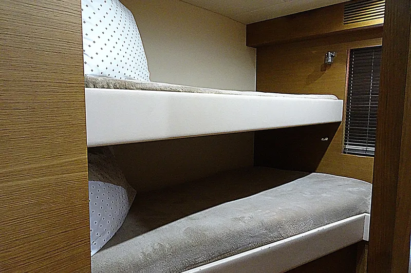 Slide: The Image of Bunk beds in 2010 Azimut 100 Leonardo yacht cabin, featuring cozy bedding and wooden interior. - 51