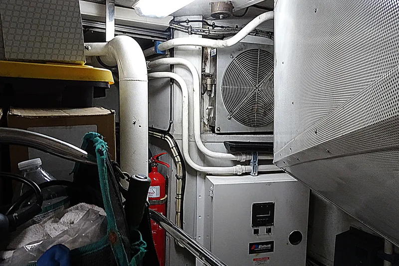 Slide: The Image of Engine room of 2010 Azimut 100 Leonardo yacht with pipes, ventilation, and fire extinguisher. - 58