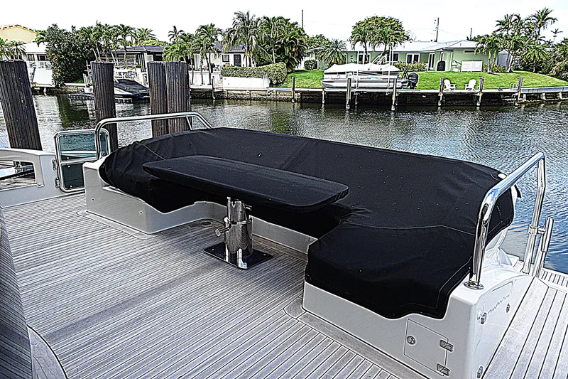 Slide: The Image of Luxury seating area on 2010 Azimut 100 Leonardo yacht, docked by waterfront homes. - 84