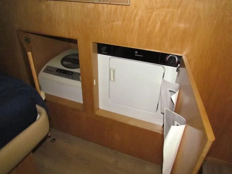 Slide: The Image of Laundry area inside a 1998 Navigator 53, featuring a washer and dryer. - 29