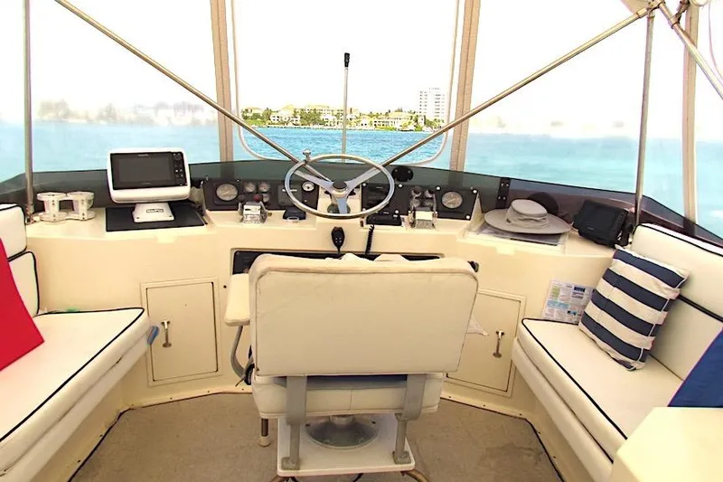 Slide: The Image of Interior helm of 1992 Hatteras 40 Motor Yacht with steering wheel and navigation equipment. - 6