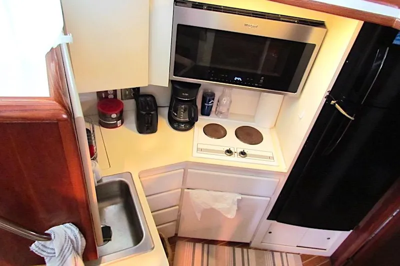 Slide: The Image of Compact kitchen in 1992 Hatteras 40 Motor Yacht with stove, microwave, and sink. - 7