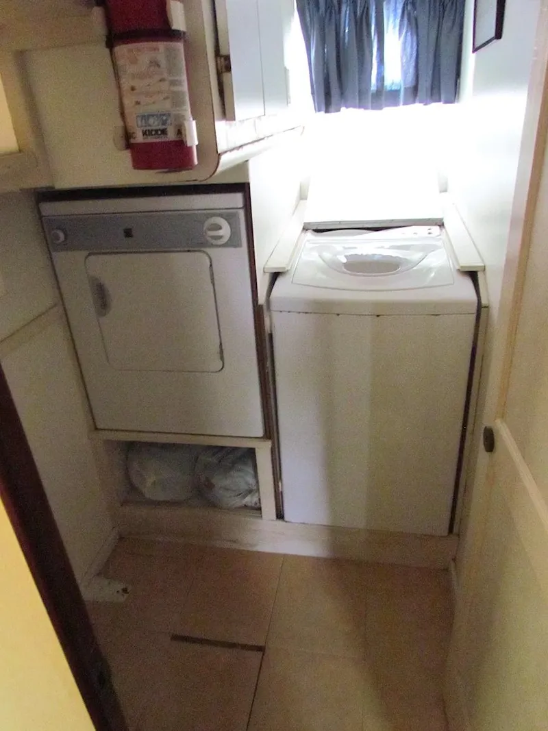 Slide: The Image of Laundry area in a 1972 Hargrave 67 Motor Yacht with washer and dryer. - 12