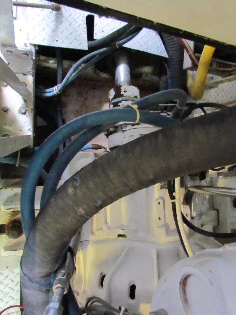 Slide: The Image of Engine room of a 1972 Hargrave 67 Motor Yacht, showing hoses and mechanical components. - 40
