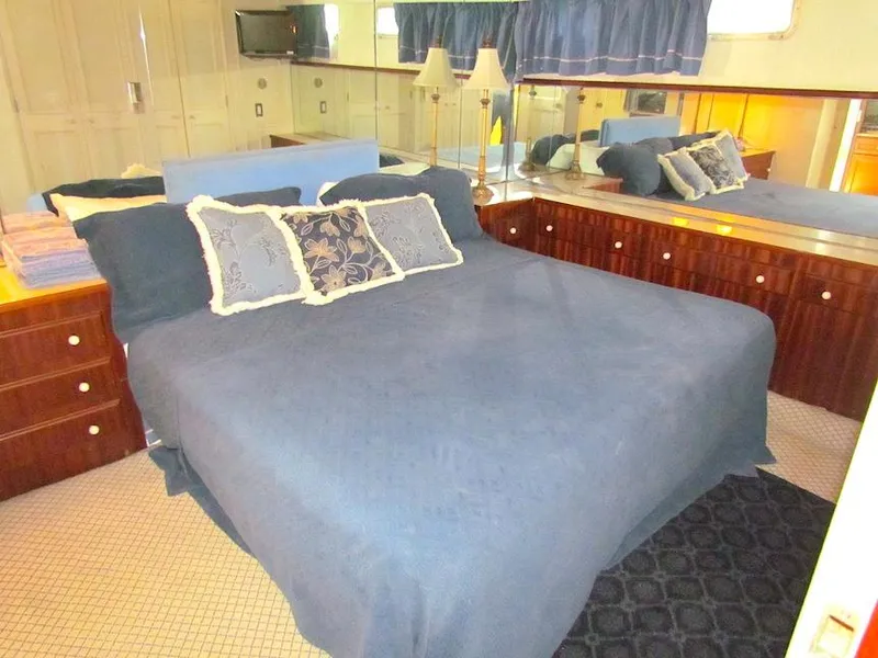 Slide: The Image of Luxurious bedroom interior of 1972 Hargrave 67 Motor Yacht with elegant bedding and mirrored wall. - 26