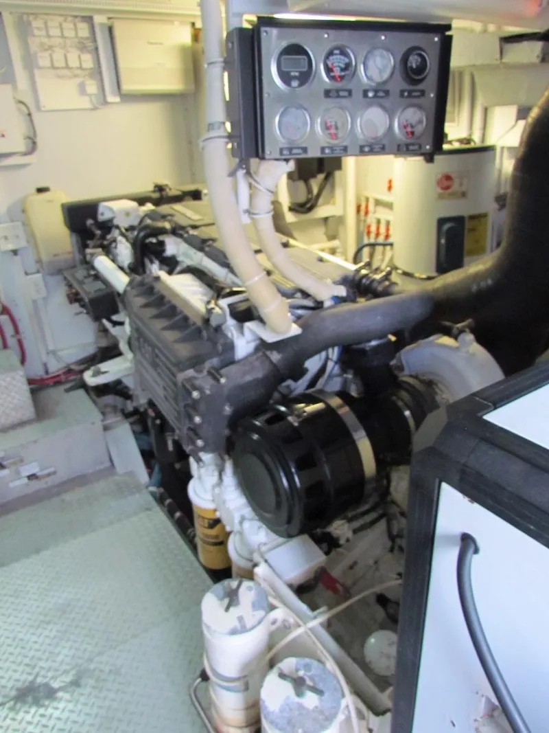 Slide: The Image of Engine room of a 1972 Hargrave 67 Motor Yacht, showcasing mechanical components and control panel. - 38
