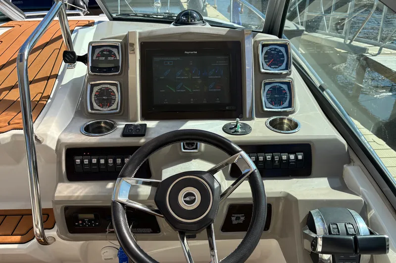 Slide: The Image of Cockpit of 2018 Chaparral 310 Signature boat with modern controls and navigation display. - 8