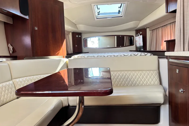 Slide: The Image of Interior of 2018 Chaparral 310 Signature boat with elegant seating and wood finishes. - 16