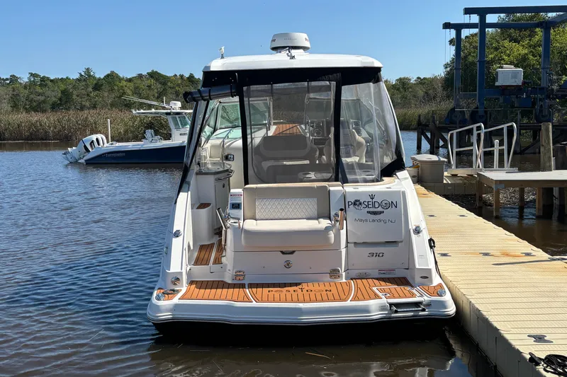 Slide: The Image of 2018 Chaparral 310 Signature boat docked at marina, rear view. - 5