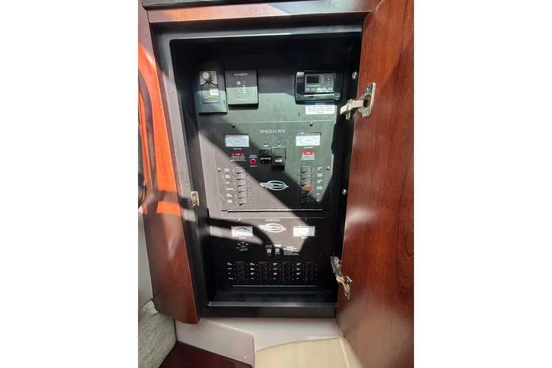 Slide: The Image of Electrical panel inside 2018 Chaparral 310 Signature boat, featuring various controls and switches. - 30