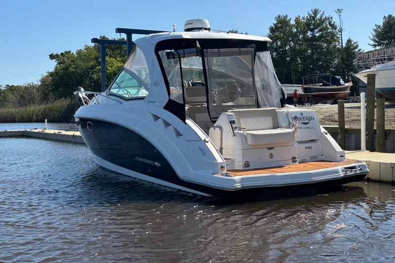 Slide: The Image of 2018 Chaparral 310 Signature boat docked at a marina, rear view. - 6