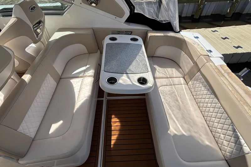 Slide: The Image of Luxurious seating area on 2018 Chaparral 310 Signature boat with elegant table and cup holders. - 12