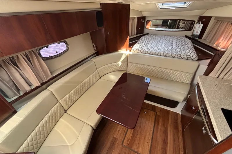 Slide: The Image of Luxurious interior of 2018 Chaparral 310 Signature boat with seating and bed. - 18