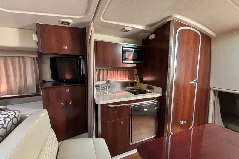 Slide: The Image of Interior of 2018 Chaparral 310 Signature yacht with kitchenette and seating area. - 21
