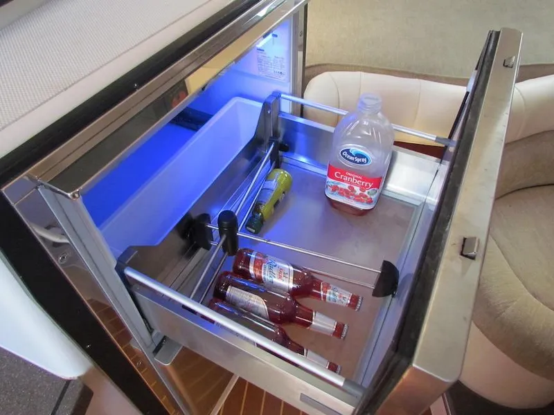 Slide: The Image of Open fridge drawer on 2008 Grady-White Express 360, containing drinks and cranberry juice. - 27