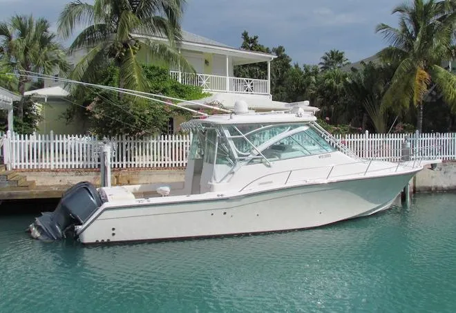 Slide: The Image of 2008 Grady-White Express 360 boat docked near tropical waterfront home. - 1