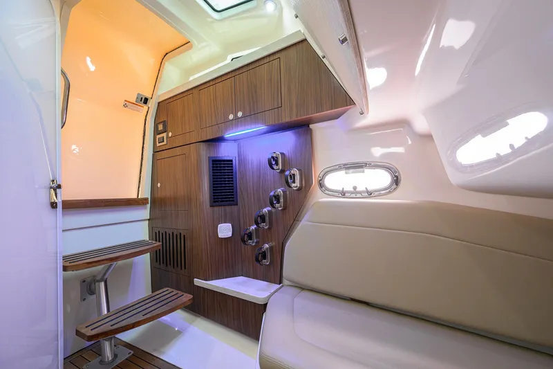 Slide: The Image of Interior of 2018 Boston Whaler 380 Outrage, featuring wooden cabinetry and seating. - 39