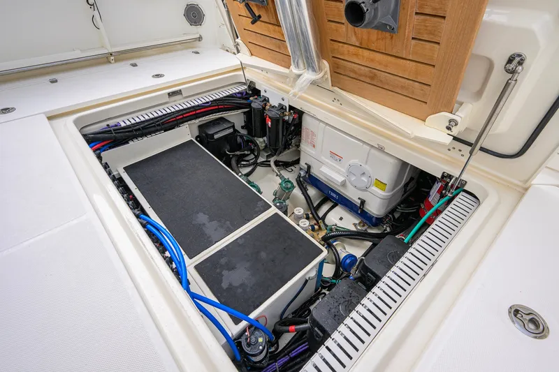 Slide: The Image of Engine compartment of a 2018 Boston Whaler 380 Outrage, showcasing wiring and components. - 67