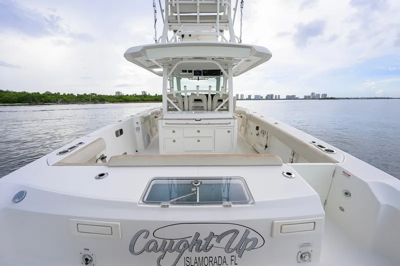 Slide: The Image of Boston Whaler 380 Outrage 2018 boat docked, featuring spacious deck and modern design. - 55