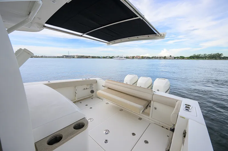 Slide: The Image of 2018 Boston Whaler 380 Outrage boat deck with seating, overlooking calm waters. - 58