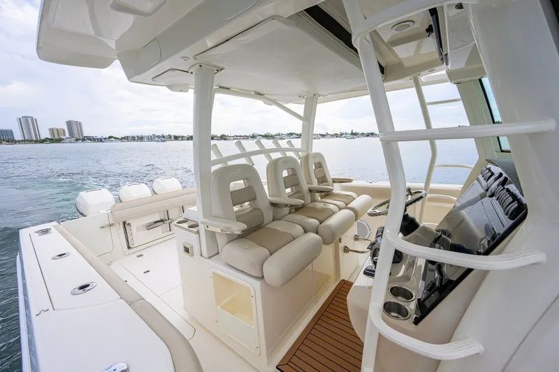 Slide: The Image of 2018 Boston Whaler 380 Outrage boat interior with luxurious seating and helm. - 32