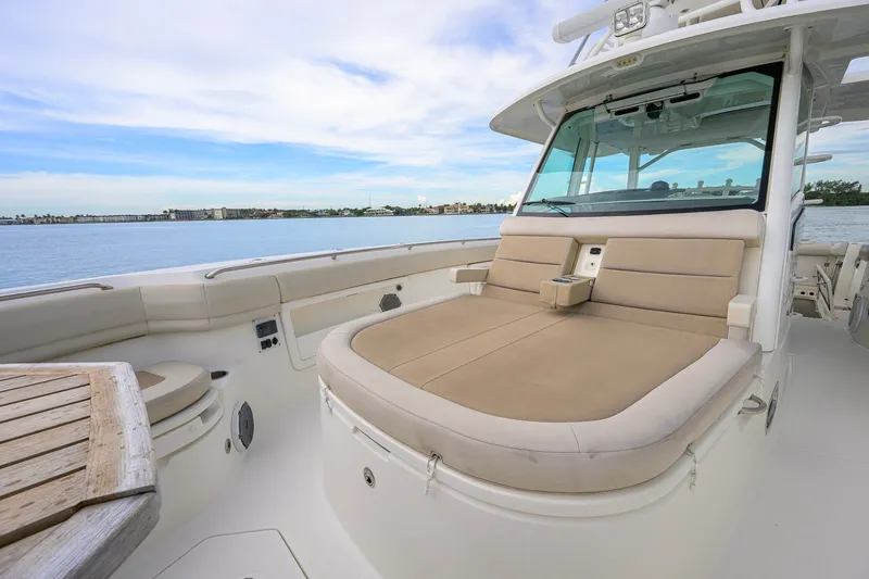 Slide: The Image of Luxurious seating on 2018 Boston Whaler 380 Outrage boat, with scenic waterfront view. - 23