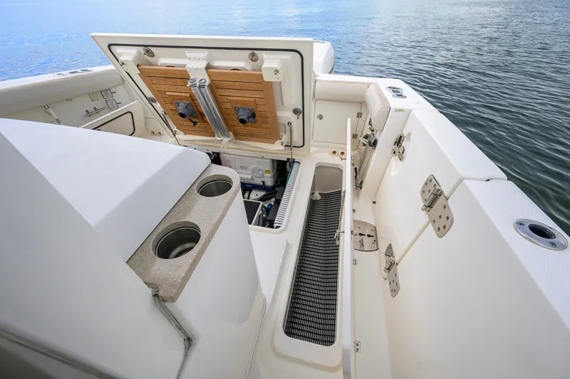 Slide: The Image of 2018 Boston Whaler 380 Outrage boat interior with open storage compartments. - 62