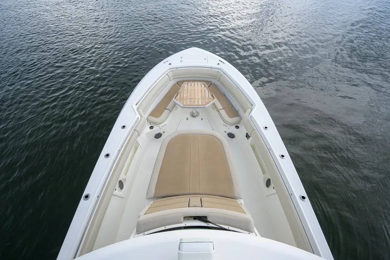 Slide: The Image of 2018 Boston Whaler 380 Outrage boat with spacious seating on calm water. - 27