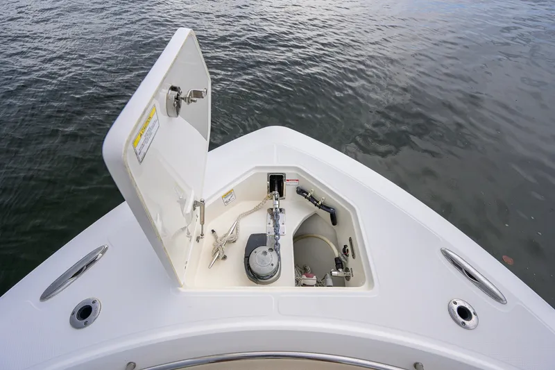 Slide: The Image of 2018 Boston Whaler 380 Outrage anchor compartment, open hatch, on calm water. - 28