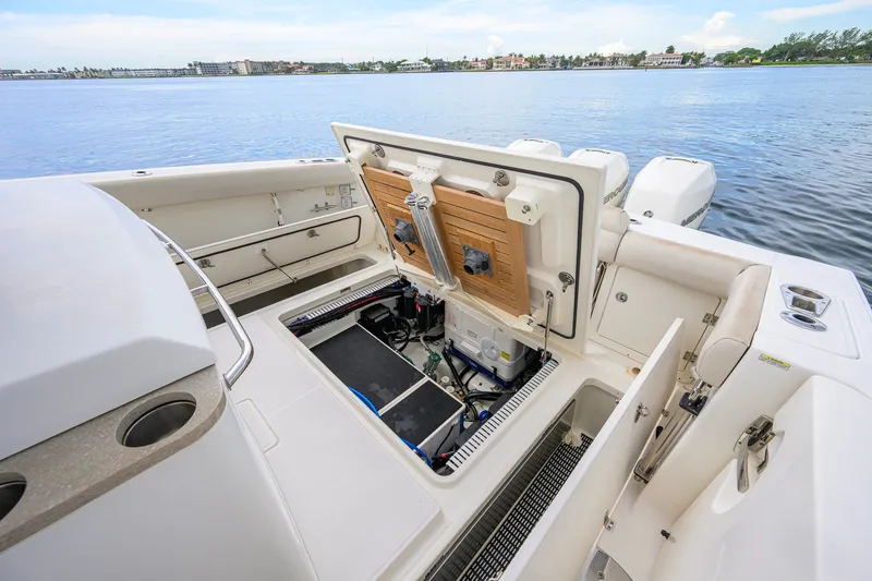 Slide: The Image of Boston Whaler 380 Outrage 2018 boat interior with open storage compartment by the water. - 63