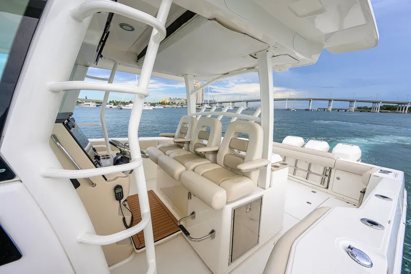 Slide: The Image of 2018 Boston Whaler 380 Outrage boat interior with luxurious seating and ocean view. - 11