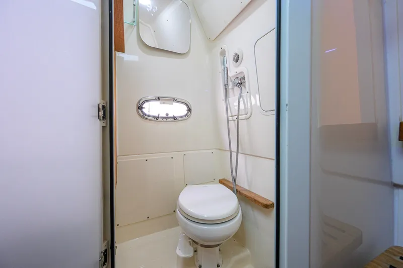 Slide: The Image of 2018 Boston Whaler 380 Outrage bathroom with toilet and showerhead. - 45