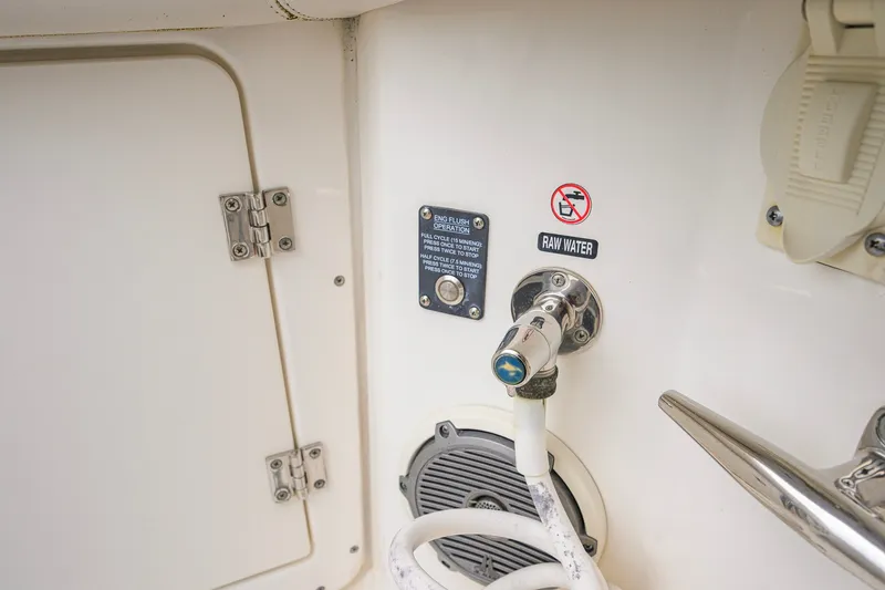 Slide: The Image of Boston Whaler 380 Outrage 2018 boat raw water hose connection and control panel. - 46
