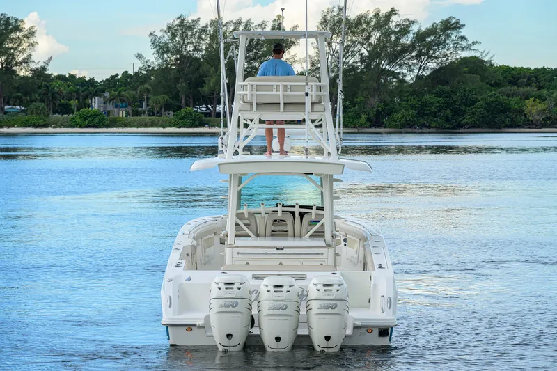Slide: The Image of 2018 Boston Whaler 380 Outrage boat with triple engines on calm water. - 6